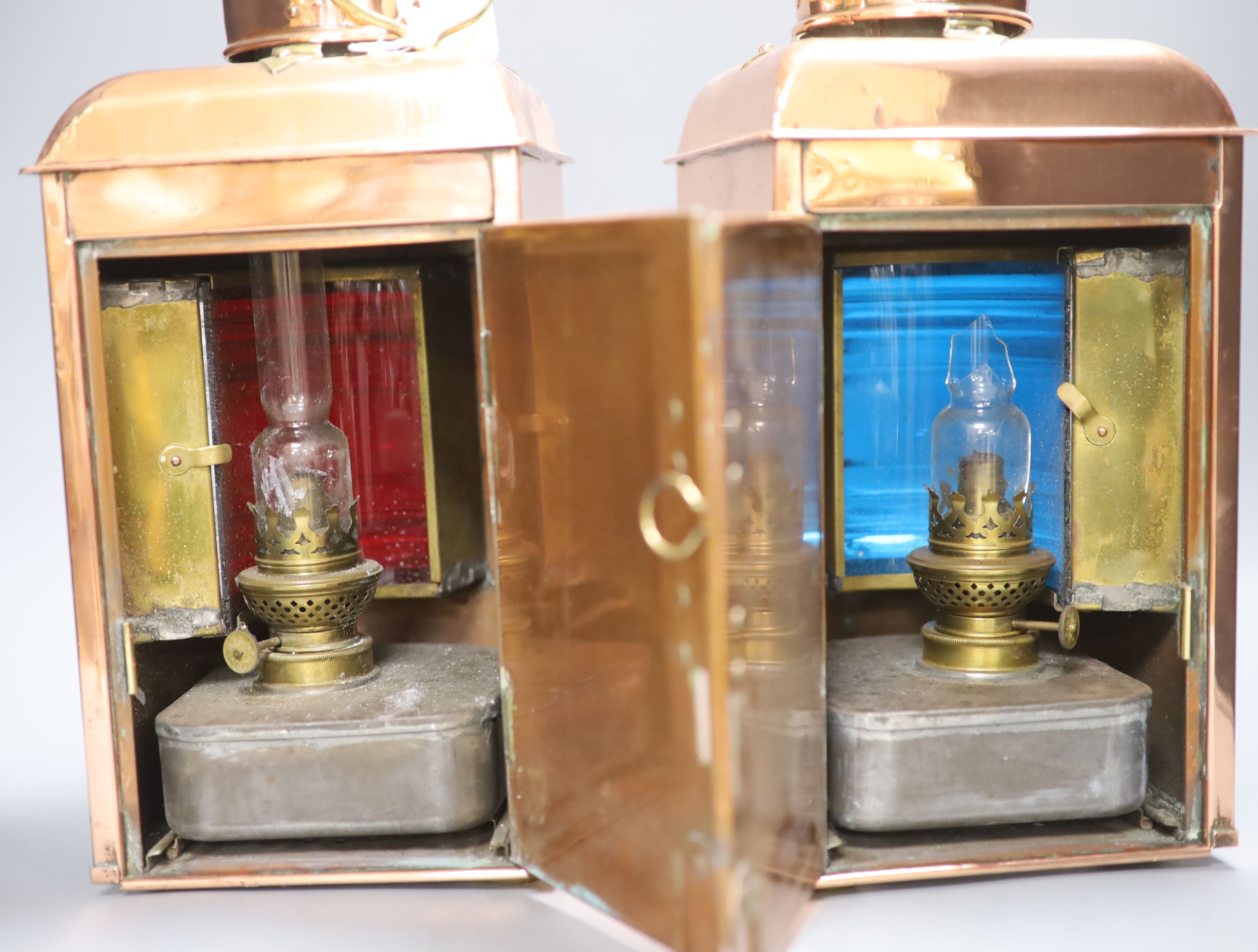 A pair of Ouvrard & Villars copper and brass ship lanterns, height 36cm